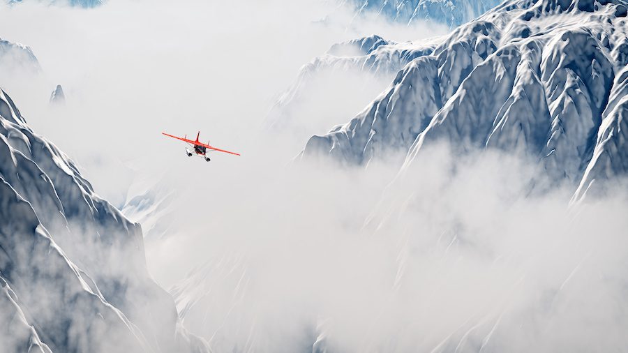 Red airplane flying over snow mountains in the clouds. Aerial shot.